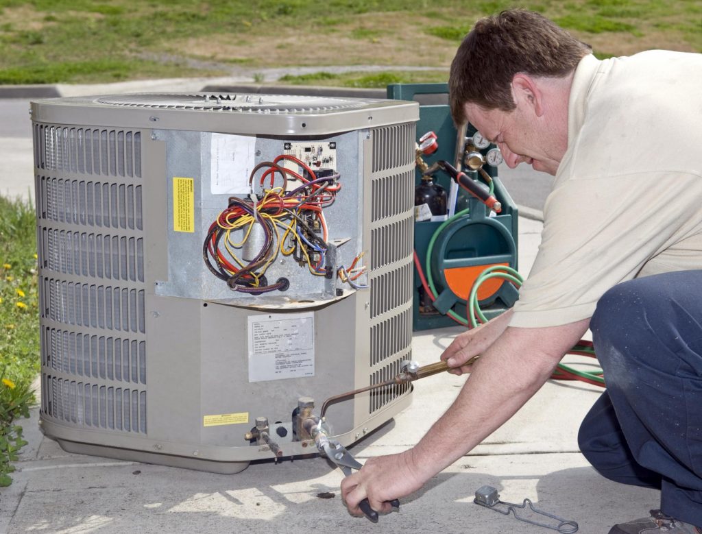 HVAC technician doing air conditioning installation